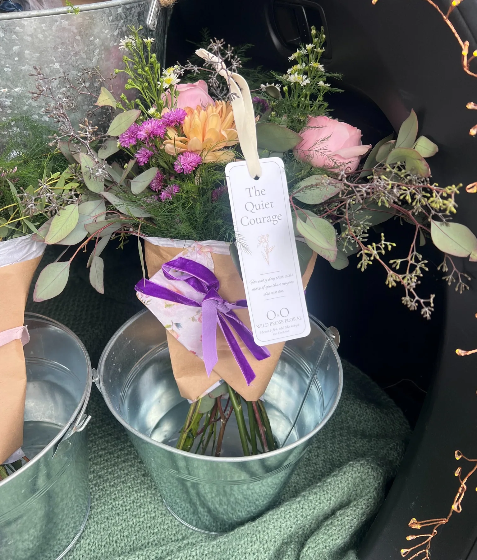 Quiet Courage bouquet featuring premium tissue, purple velvet ribbon and signature bookmark
